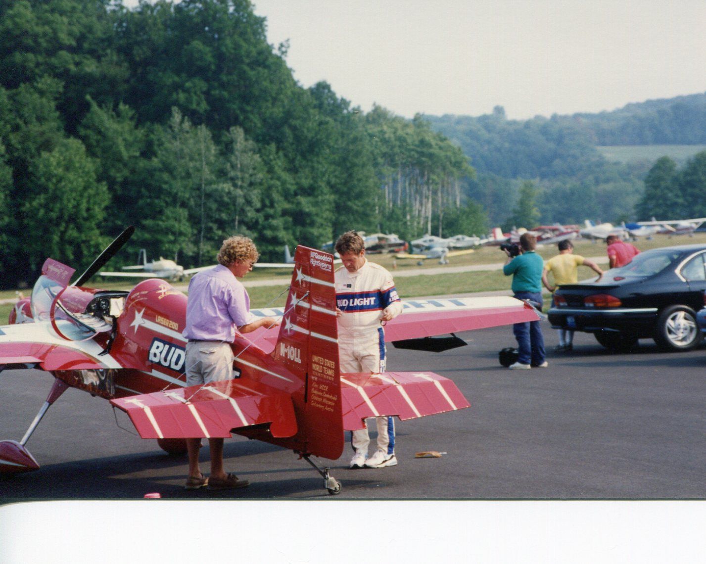 STEPHENS Akro (N10LL) - SUSSEX AIRPORT, SUSSEX, NEW JERSEY, USA-AUGUST 1993: Pictured on the right, in his white flight suit, performing some last minute checks on his AKRO Laser 200 aircraft is former U.S. National and World Aerobatic Champion pilot Leo Loudenslager. This picture was taken during the 1993 Sussex Airshow.