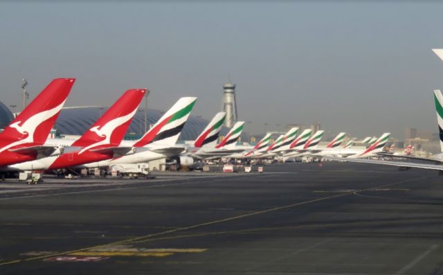 Airbus A380-800 (VH-OQA) - Grainy, but a good view of a busy packed terminal of Emirates aircraft and two Qantas Airbus A380s