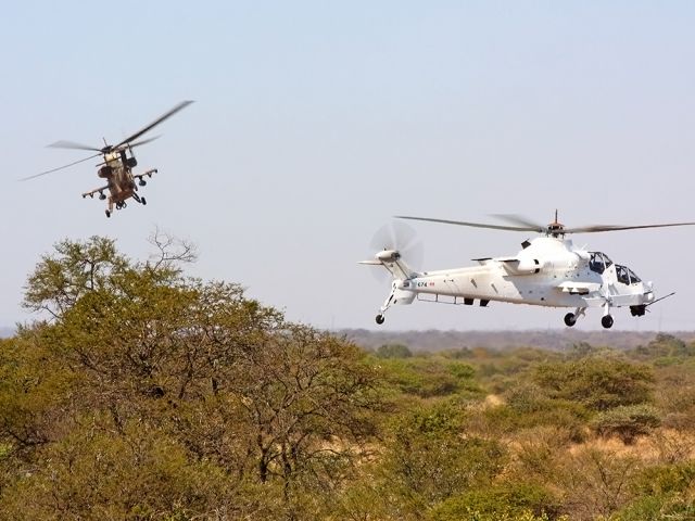 — — - Two South African Air Force Rooivalk AH2's during the Biennial air power capability demonstration
