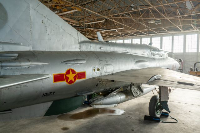 MIKOYAN MiG-21 (N21EV) - A dusty and leaky MIG-21 Fishbed sits in the hangar at Ellington Field's Vietnam Flight Museum.