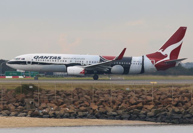 VH-XZJ — - XZJ Getting her nose gear off 34L as she departs pretty heavy. Taken from The Beach with a 70-200mm