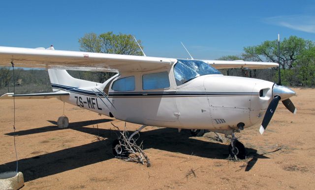 Cessna Centurion (ZS-MFL) - Thorn bushes around the tyres, to prevent hyaenas chewing them. Ingwelala, South Africa.