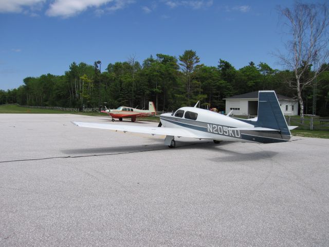 Mooney M-20 (N205KD) - At the Mackinac Island Airport, June 2007.  1967 or 68 Mooney Executive (M20F) in the background.