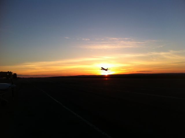Boeing 757-200 (C-FKCJ) - After many attempts I finally got the Perfect Shot Cargojet 757-200 Departing Moncton Runway 29 to Hamilton rotates at the right moment to cross paths with the setting sun
