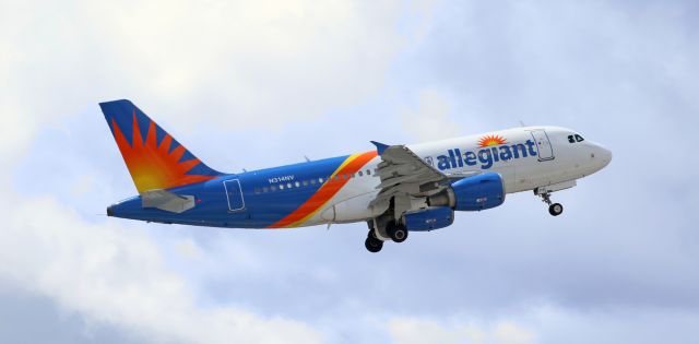 Airbus A319 (N314NV) - The pilots are putting the tread to bed as AAY's N314NV climbs into a partly cloudy sky.