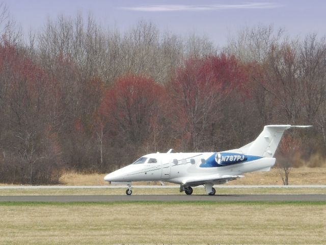 Embraer Phenom 100 (N787PJ) - Shown here departing in the Spring of 2014 is this Embraer Phenom 100 business Jet.