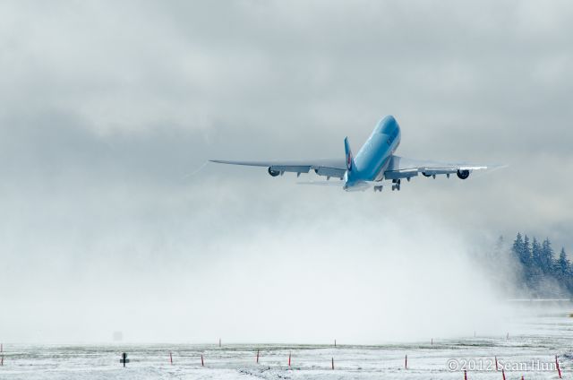 HL7617 — - BOE547 taking off runway 16R, blowing some snow!