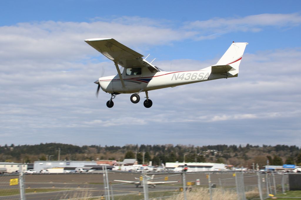 Cessna Commuter (N436SA) - Cessna 150 demonstrating how close aircraft would get to the perimeter fence. A few months later, the fence was moved back for safety. 
