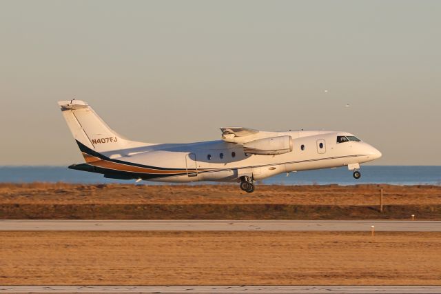 Fairchild Dornier 328JET (N407FJ) - UJC901 during an early morning departure on RWY 6L amidst a scenic Cleveland/Lake Erie backdrop. Ultimate 901 was en route to Cincinnati Muni (KLUK).