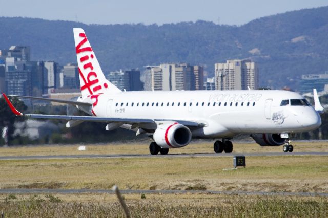 Embraer ERJ-190 (VH-ZPR) - On taxi-way, heading for take off on runway 05. Adelaide city skyline visible in the background. Friday, 19th April 2013.