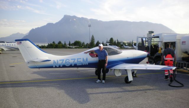 Lancair Legacy 2000 (N767EM) - Refueling at Mozart Airport in Salzburg, Austria ... N767EM is parked opposite Hangar 7 (the glass hangar) where you may visit N25Y, the P38 Lightning as well as others in the Red Bull collection. Admission to the glass hangar is FREE and there are 3 restaurants in the hangar. The multi-lingual staff is excellent and so is the food.