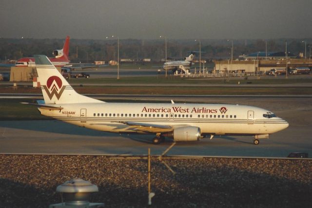 BOEING 737-300 (N324AW) - Notice the three holer eye candy in the back-ground!