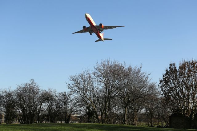 Boeing 777-200 — - The approach was normal then the order was given to go around. The Angle of attack looks dramatic from this angle, but it has taken several attempts to get this shot from this angle, showing the tree's and ground in the foreground.