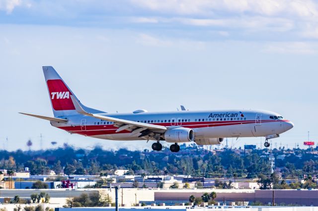 Boeing 737-800 (N915NN) - An American Airlines 737-800 in TWA retro livery landing at PHX on 2/28/23. Taken with a Canon R7 and Canon EF 100-400 L ii lens.