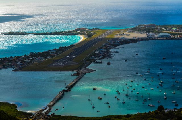 — — - St. Maarten airport from an high angle with Winair taking off...