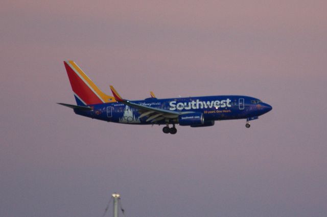 Boeing 737-700 (N954WN) - Southwest's new special color scheme - Walt Disney 50 Years arriving to Boston Logan at dusk on 10/12/21. 