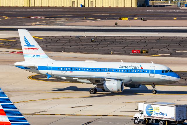 Airbus A319 (N744P) - An American Airlines A319 in Piedmont retro livery taxiing at PHX on 2/28/23. Taken with a Canon R7 and Canon EF 100-400 L ii lens.