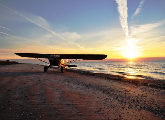 — — - Sunrise on a remote beach by Lake Michigan