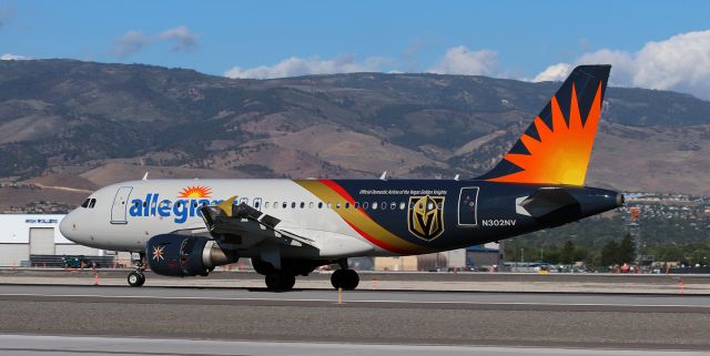 Airbus A319 (N302NV) - Using every stopping method available (brakes, wing devices, and reverse thrust); Allegiant's Las Vegas Golden Knights special paintbird (N302NV) is slowing after landing on 16L.