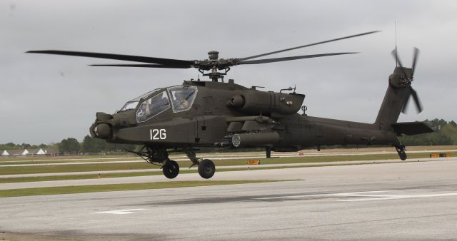 Boeing Longbow Apache (ARMY41412) - A Boeing AH-64E Apache Guardian lifting from the Gulf Air Center ramp at Jack Edwards National Airport, Gulf Shores, AL - March 27, 2018. The two vague spots on the upper left side of the image are grit being kicked up by the rotors.