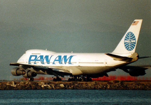 BOEING 747-100 (N727PA) - KSFO - N727PA on the hold bars at SFO short of Runways 28 LR. Clipper Belle of the Sky set to depart to the Orient in the mid 1980s view. 1000mm Lens photo- Minolta XD-11 100ASA.