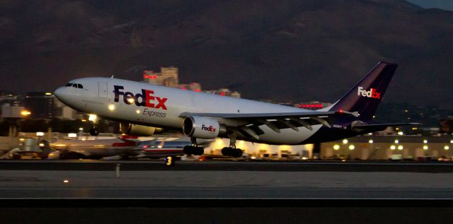 Airbus A300F4-600 (N659FE) - Fed Exs "Calvin" (N659FE), an A306, is captured here arriving at Reno Tahoe International just as the first light of a new day is beginning to bring dawn to the Truckee Meadows.