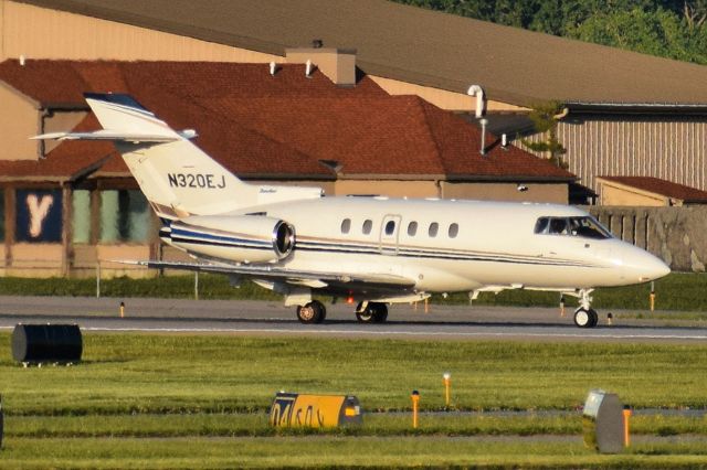 Hawker 800 (N320EJ) - Privately Owned Hawker 800XP back-taxiing on Runway 23 at the Buffalo Niagara International Airport after arriving from Oklahoma City (OKC)