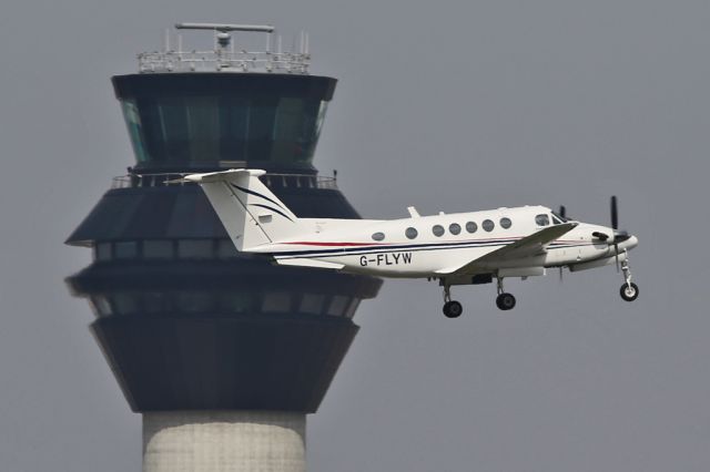 Beechcraft Super King Air 200 (G-FLYW) - Departing past the new control tower at Manchester