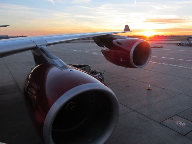 Airbus A340-600 (G-VGAS) - Sunset over LHR. Taken from part way up the stairs.  Boarded from the ground away from the gate area - odd experience on such a large aircraft.