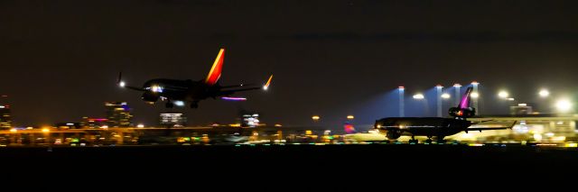 Boeing MD-11 — - FedEx MD11 taking off from runway 25R while a Southwest Airlines 737-800 lands on runway 25L at PHX on 8/31/22. Taken with a Canon 850D and Rokinon 135mm f/2 manual focus lens.