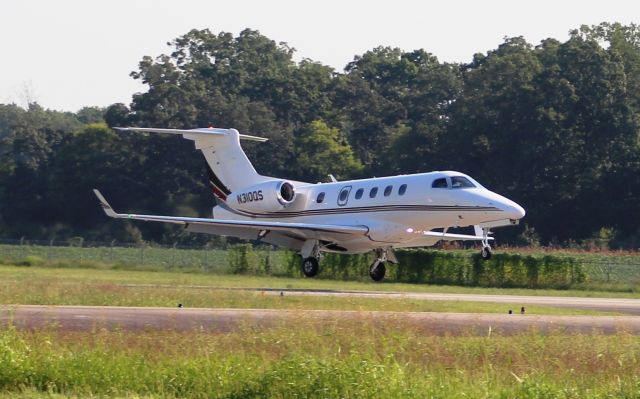 Embraer Phenom 300 (N310QS) - An Embraer Phenom 300 landing on Runway 18 at Pryor Field Regional Airport in Decatur, AL on September 6, 2016. Shot with a Canon T5 using the 75mm-300mm lens in sports mode from the edge of the ramp nearest the taxiway.