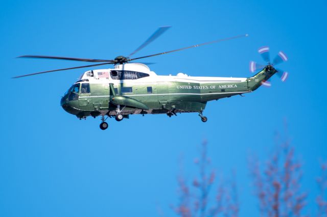 — — - Marine one, flying tree top level, to Camp David