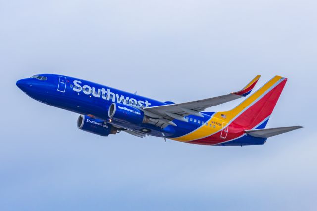 Boeing 737-700 (N7715E) - A Southwest Airlines 737-700 taking off from PHX on 2/13/23, the busiest day in PHX history, during the Super Bowl rush. Taken with a Canon R7 and Canon EF 100-400 II L lens.