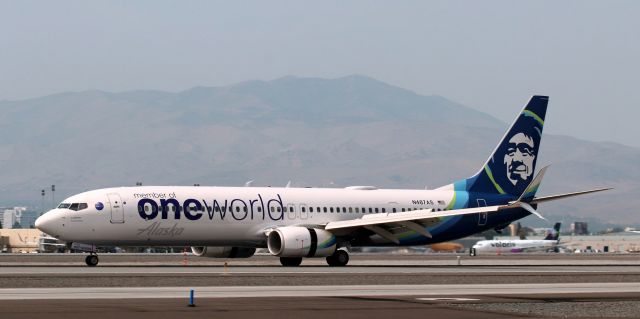 Boeing 737-900 (N487AS) - Alaska's "oneworld" special livery dirties up the wing surfaces and reverses the thrust after landing on 16L at the end of a SEA-RNO trip.