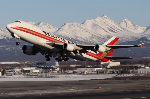 Boeing 747-400 (N403KZ) - Takeoff at sunset, Flattop in view from west side of Runway 15-33 along Pt. Woronzof Rd.