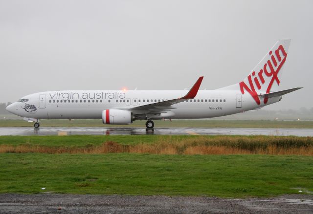 Boeing 737-800 (VH-YFN) - Virgin Australia B737-800 VH-YFN. Taxiing the bay on its 1st visit to Adelaide on what was a wet and miserable day.