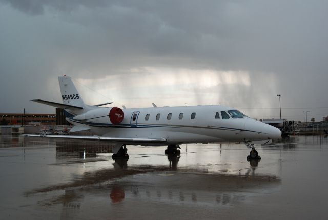 Cessna Citation Excel/XLS (FIV549) - On the TacAir ramp after a shower blew thru. Oct 20, 2009