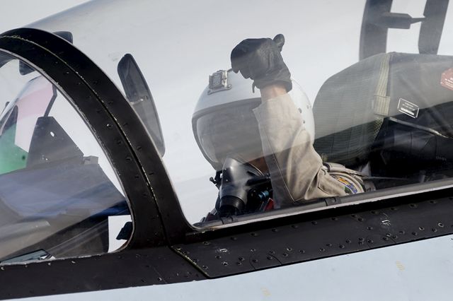 — — - A pilot of a Sukhoi Su-30 fighter jet gestures before taking off at the Hmeymim air base near Latakia, Syria, in this handout photograph released by Russias Defence Ministry October 22, 2015. (Photo by Reuters/Ministry of Defence of the Russian Federation)