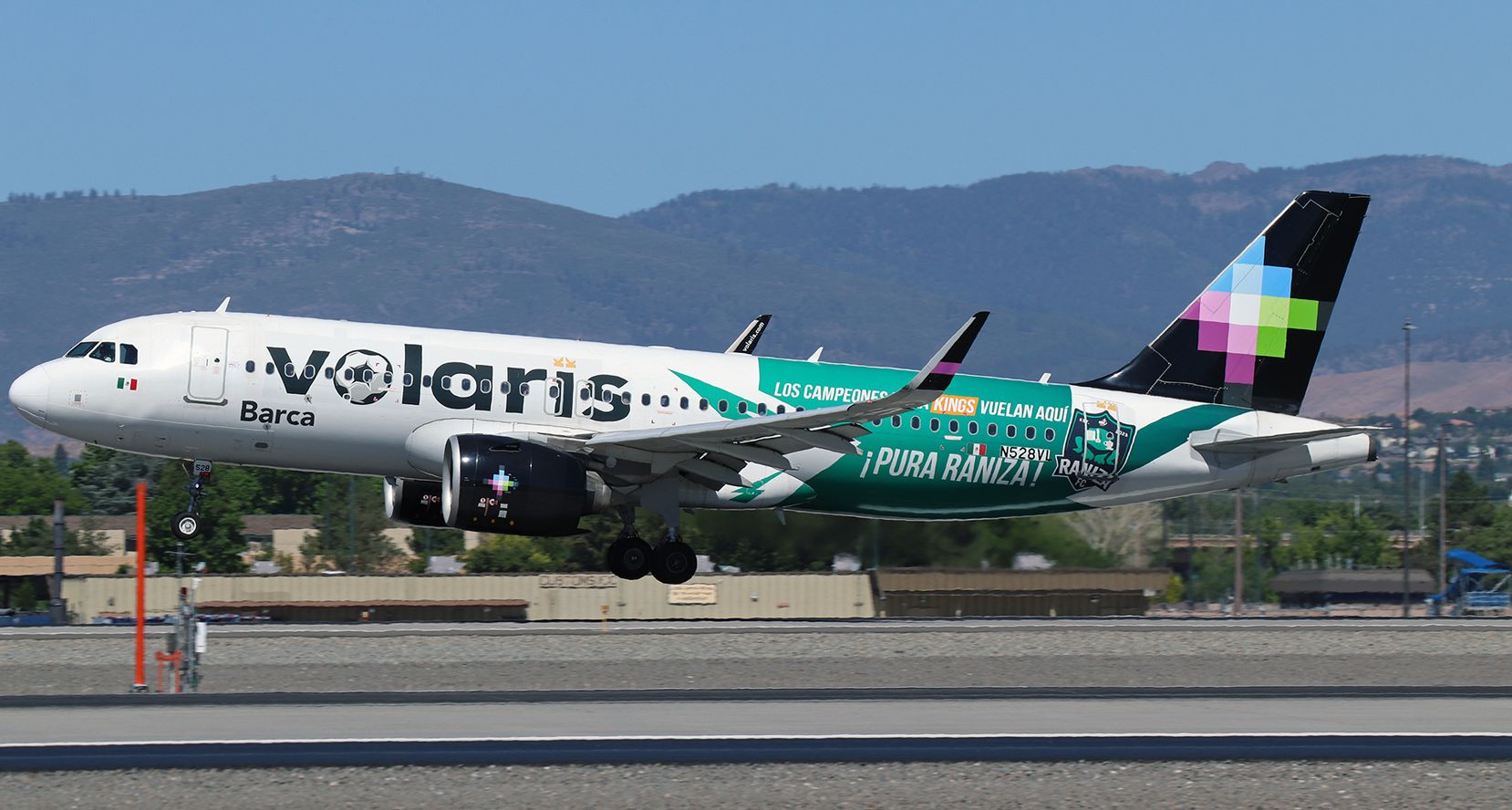 Airbus A320neo (N528VL) - VOI's Airbus (N528VL) with the special soccer livery and named "Barca" (for the FC Barcelona team) is just about to complete a flight from Guadalajara and touch down on 17R.