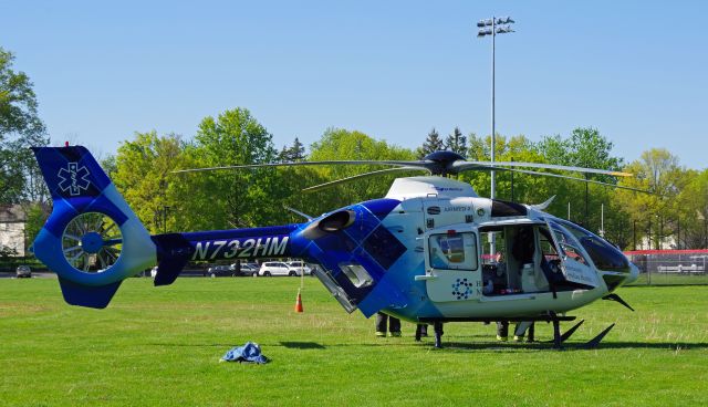 Eurocopter EC-635 (N732HM) - RAHWAY, NEW JERSEY, USA-MAY 09, 2022: A medical transportation helicopter is seen on the ground in front of the Rahway Middle School preparing for a flight from Robert Wood Johnson Hospital-Rahway, N.J. to Robert Wood Johnson Hospital-New Brunswick, N.J. When transporting to or from RWJ-Rahway, the helicopter will use the school's ball field as a landing zone because the hospital lacks a permanent fixed heli-pad. As such, it uses the nearest fixed heli-pad as its landing code, Merck & Company's 7NJ8, located about a mile away.