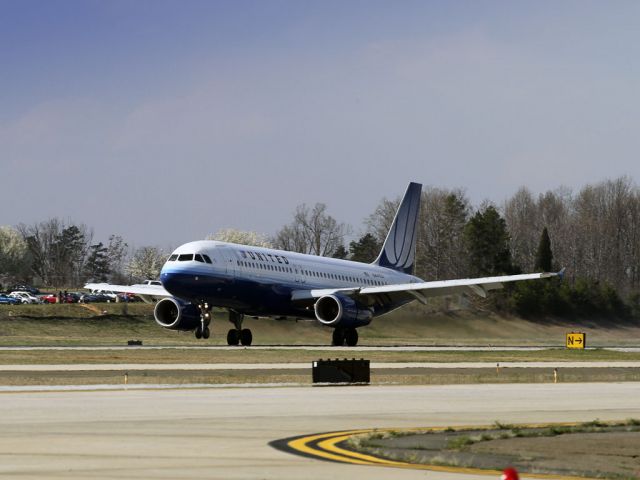 Airbus A320 (N441UA) - Late afternoon landing on runway 18C at Charlotte, North Carolina USA. The Charlotte Airport viewing area is off the right wing. Photo taken Sunday, 13 March 2011, about 4:25 pm.