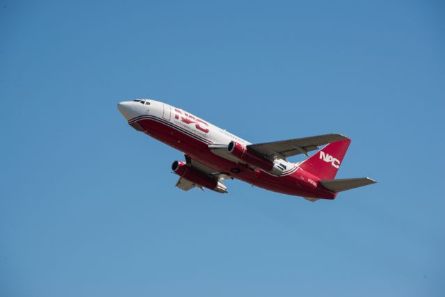 Boeing 737-200 (N322DL) - NAC summer takeoff Runway 33, shot from the West side of the airport looking E.