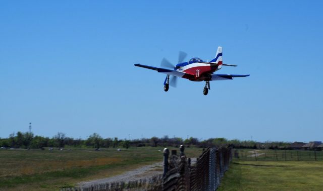 North American P-51 Mustang (N991R) - Miss America Crossing the perimeter fence for 17R at KPWA on 03-APR-2016