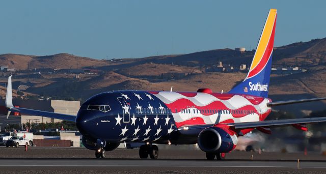 Boeing 737-800 (N500WR) - The reflection on the nose of Southwest's "Freedom One" reveals that the sun has just come up over the Virginia Range Mountains east of Reno Tahoe International as N500WR races along Runway 17L to depart RNO at 7:06 AM enroute to Daugherty Field (KLGB) in Long Beach .