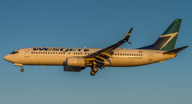 Boeing 737-800 (C-GWSA) - Morning light on this Westjet 738 on finals for runway 23