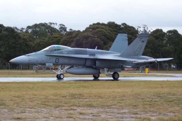 A2135 — - Photo depicts the third Royal Australian Air Force F/A-18 Hornet (A21-35) of a five jet package from 3 Sqdn taxing to the runway for an afternoon training sortie at RAAF Williamstown.  The RAAF utilizes the Hornet as its primary fighter aircraft; this aircraft is equipped with (at least) one LAU-7/ A-7 air-to-air missile (left wingtip weapons station; roughly comparable to the US AIM-9 Sidewinder air-to-air missile) as well as the 20mm M61 Vulcan Cannon mounted in the aircrafts nose.  I shot the photo with my Kodak V1233 Zoom Digital Camera at 2:38:21 PM Local Time on 24 July 2008 using 1/125 sec exposure time, and the photo is cropped to an (approximate) 2959 x 1972 pixel value.