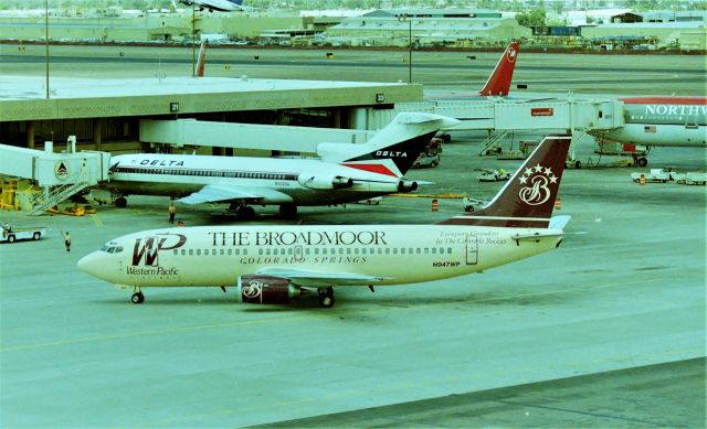 BOEING 737-300 (N947WP) - KPHX - Western Pacific arriving at Phoenix 1999?? The Delta 727 is N508DA and the NWA DC-10 is N154US. The parking structures at Phoenix offer great photo vantage points.