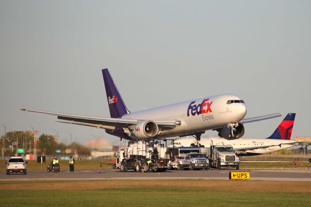 BOEING 767-300 (N127FE) - FDX356 Heavy arriving on RWY 24R just before sunset on 8 Oct 2020 with painters striping an adjoining taxiway.