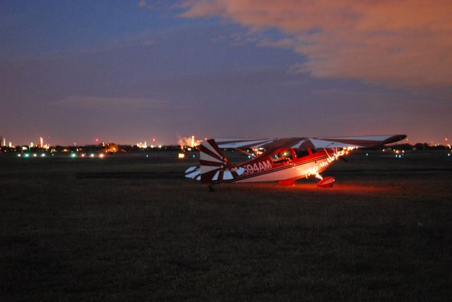 CHAMPION Decathlon (N594AM) - Nothing speak of the joy of Christmas like a red and white aerobatic plane! Here we are off runway 05 at La Porte