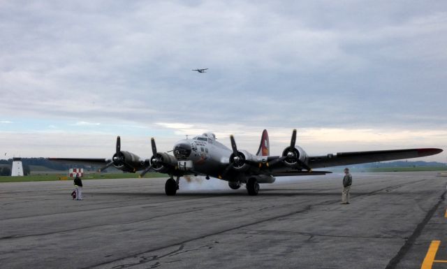 Boeing B-17 Flying Fortress (N5017N) - Shown here firing up the Engines is a 1945 Lockheed B-17G Flying Fortress "Aluminum Overcast" World War II Bomber. Aircraft making a tour stop courtesy of the Experimental Aircraft Association in the Autumn of 2018. Cessna Caravan N900JA departing in the scene.